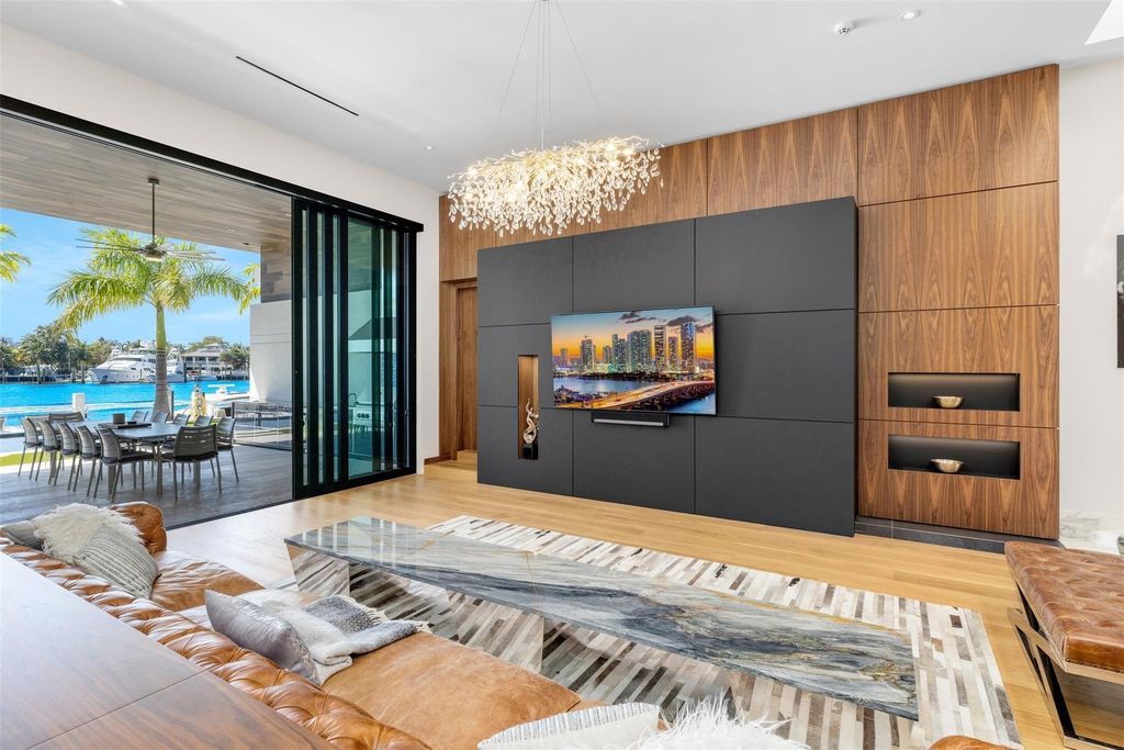 Rebuilt in July 2023, this single-story smart home offers 5,073 square feet of sophisticated living space on a sprawling 15,300-square-foot lot with a 2,300-square-foot dock adorned with coral stone from Spain.