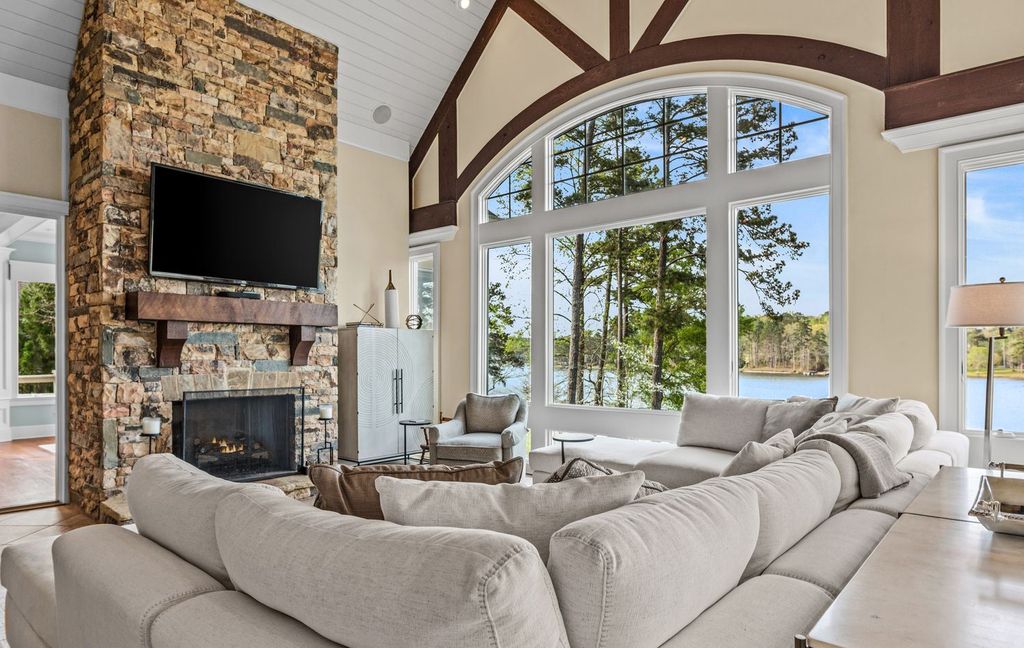 1461 North Shore Drive Home in Greensboro, Georgia. Discover unmatched luxury at this stunning family lake house near the Ritz and LakeClub. Enjoy expansive lake views, resort-style infinity pool, 4-car garage, spacious suites, two kitchens, and an elevator. 