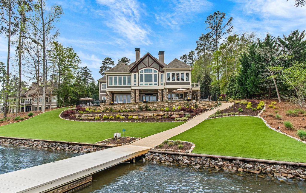 1461 North Shore Drive Home in Greensboro, Georgia. Discover unmatched luxury at this stunning family lake house near the Ritz and LakeClub. Enjoy expansive lake views, resort-style infinity pool, 4-car garage, spacious suites, two kitchens, and an elevator. 