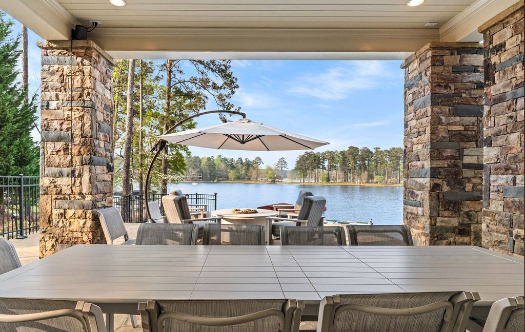 1461 North Shore Drive Home in Greensboro, Georgia. Discover unmatched luxury at this stunning family lake house near the Ritz and LakeClub. Enjoy expansive lake views, resort-style infinity pool, 4-car garage, spacious suites, two kitchens, and an elevator. 
