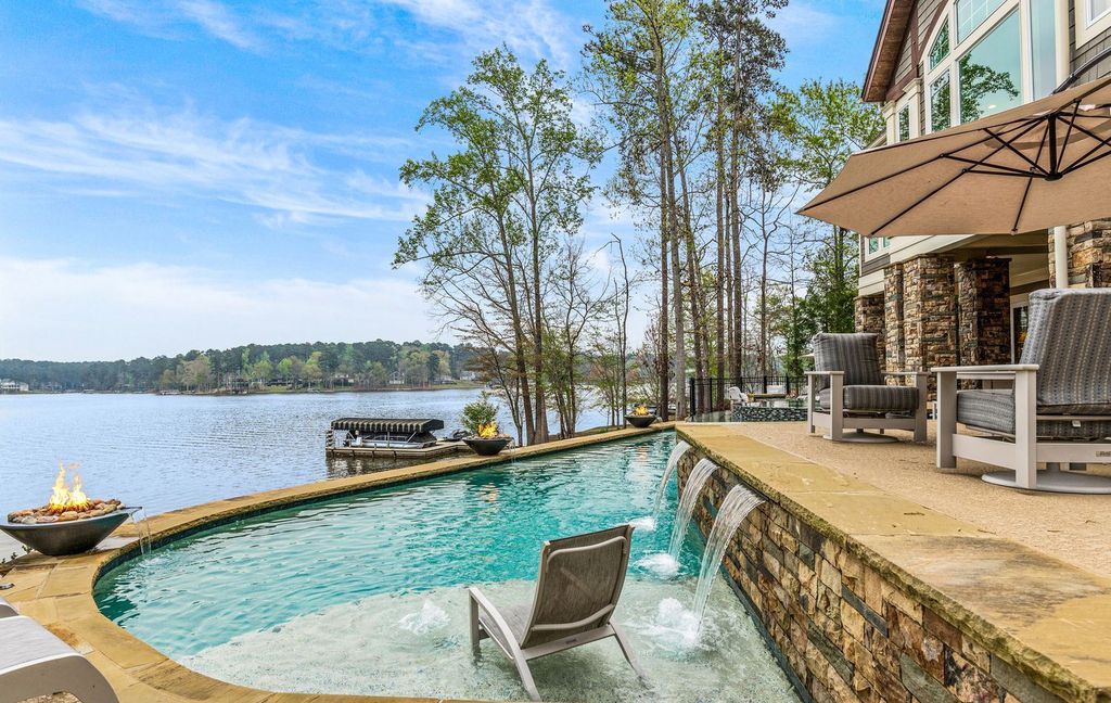 1461 North Shore Drive Home in Greensboro, Georgia. Discover unmatched luxury at this stunning family lake house near the Ritz and LakeClub. Enjoy expansive lake views, resort-style infinity pool, 4-car garage, spacious suites, two kitchens, and an elevator. 