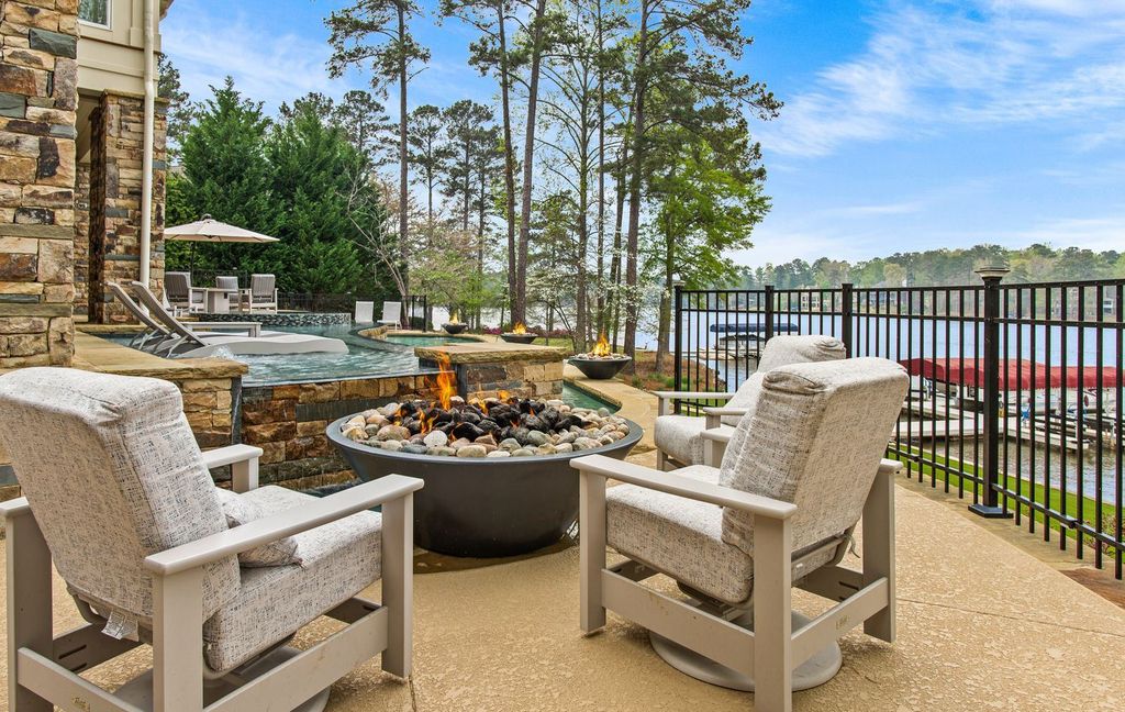 1461 North Shore Drive Home in Greensboro, Georgia. Discover unmatched luxury at this stunning family lake house near the Ritz and LakeClub. Enjoy expansive lake views, resort-style infinity pool, 4-car garage, spacious suites, two kitchens, and an elevator. 