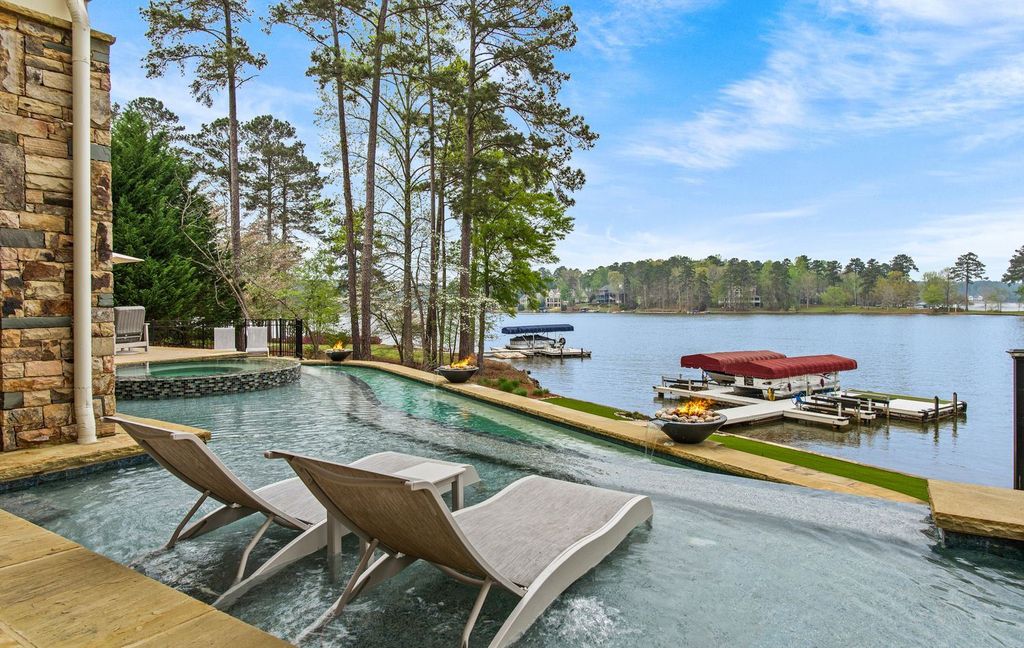 1461 North Shore Drive Home in Greensboro, Georgia. Discover unmatched luxury at this stunning family lake house near the Ritz and LakeClub. Enjoy expansive lake views, resort-style infinity pool, 4-car garage, spacious suites, two kitchens, and an elevator. 