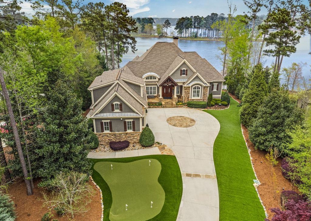 1461 North Shore Drive Home in Greensboro, Georgia. Discover unmatched luxury at this stunning family lake house near the Ritz and LakeClub. Enjoy expansive lake views, resort-style infinity pool, 4-car garage, spacious suites, two kitchens, and an elevator. 