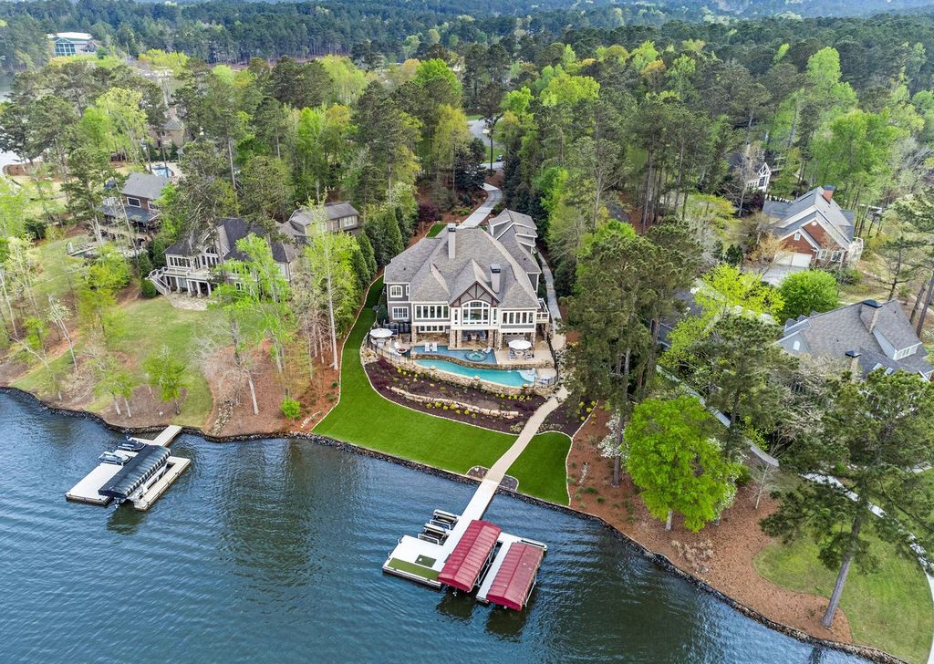 1461 North Shore Drive Home in Greensboro, Georgia. Discover unmatched luxury at this stunning family lake house near the Ritz and LakeClub. Enjoy expansive lake views, resort-style infinity pool, 4-car garage, spacious suites, two kitchens, and an elevator. 