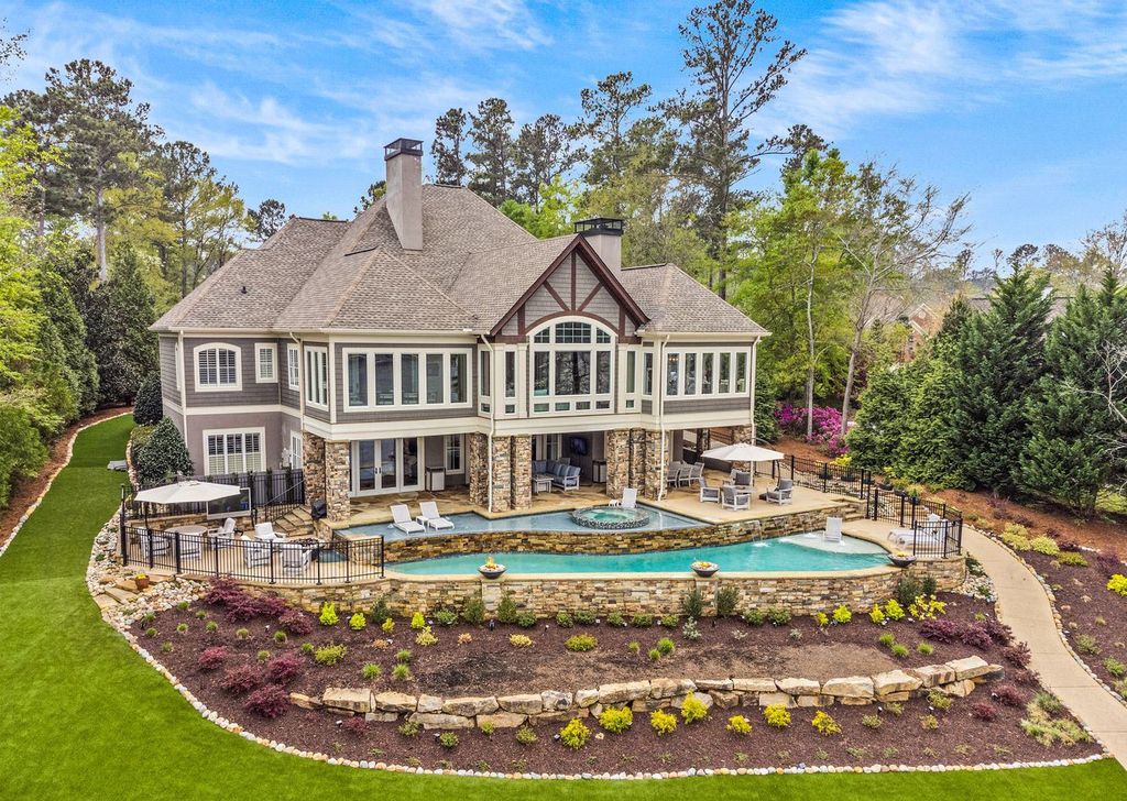 1461 North Shore Drive Home in Greensboro, Georgia. Discover unmatched luxury at this stunning family lake house near the Ritz and LakeClub. Enjoy expansive lake views, resort-style infinity pool, 4-car garage, spacious suites, two kitchens, and an elevator. 