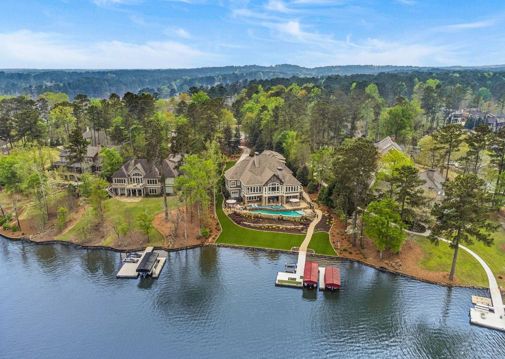 1461 North Shore Drive Home in Greensboro, Georgia. Discover unmatched luxury at this stunning family lake house near the Ritz and LakeClub. Enjoy expansive lake views, resort-style infinity pool, 4-car garage, spacious suites, two kitchens, and an elevator. 