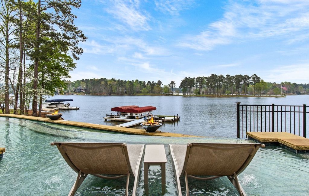 1461 North Shore Drive Home in Greensboro, Georgia. Discover unmatched luxury at this stunning family lake house near the Ritz and LakeClub. Enjoy expansive lake views, resort-style infinity pool, 4-car garage, spacious suites, two kitchens, and an elevator. 