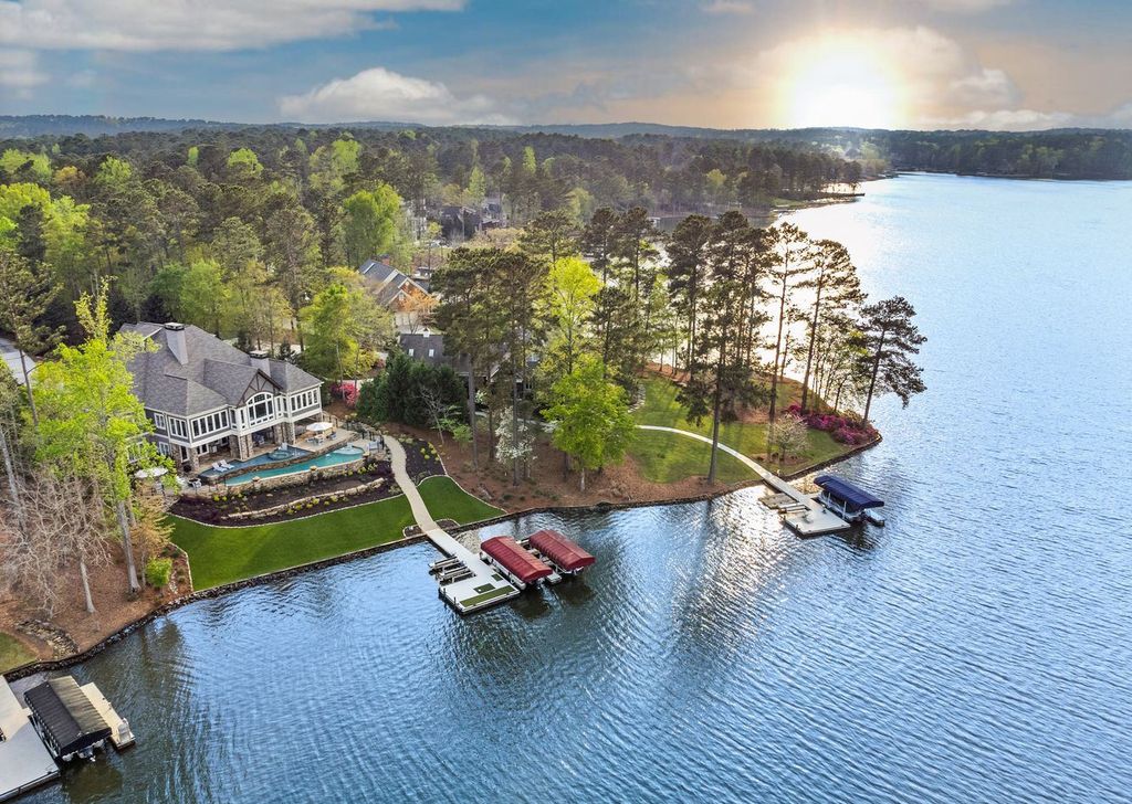 1461 North Shore Drive Home in Greensboro, Georgia. Discover unmatched luxury at this stunning family lake house near the Ritz and LakeClub. Enjoy expansive lake views, resort-style infinity pool, 4-car garage, spacious suites, two kitchens, and an elevator. 