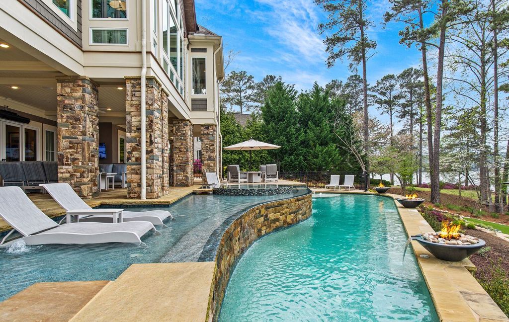 1461 North Shore Drive Home in Greensboro, Georgia. Discover unmatched luxury at this stunning family lake house near the Ritz and LakeClub. Enjoy expansive lake views, resort-style infinity pool, 4-car garage, spacious suites, two kitchens, and an elevator. 