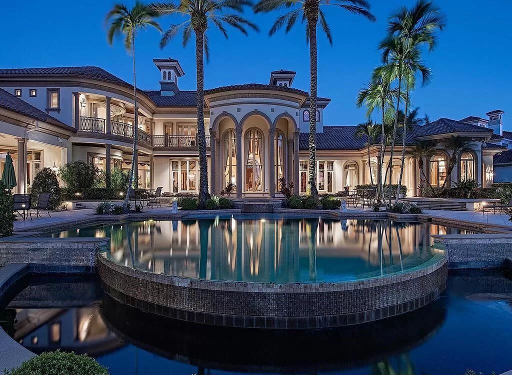 Discover unparalleled luxury living in the prestigious Estates at Bay Colony with this exquisite European-inspired residence nestled on a double lakefront estate.
