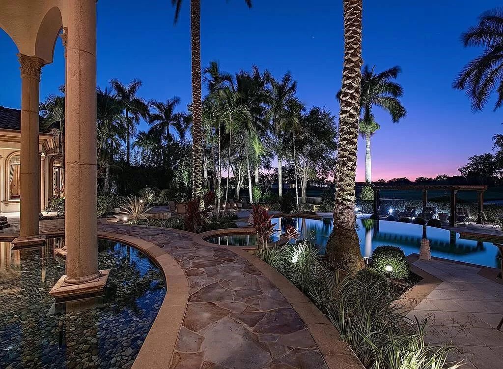 Discover unparalleled luxury living in the prestigious Estates at Bay Colony with this exquisite European-inspired residence nestled on a double lakefront estate.