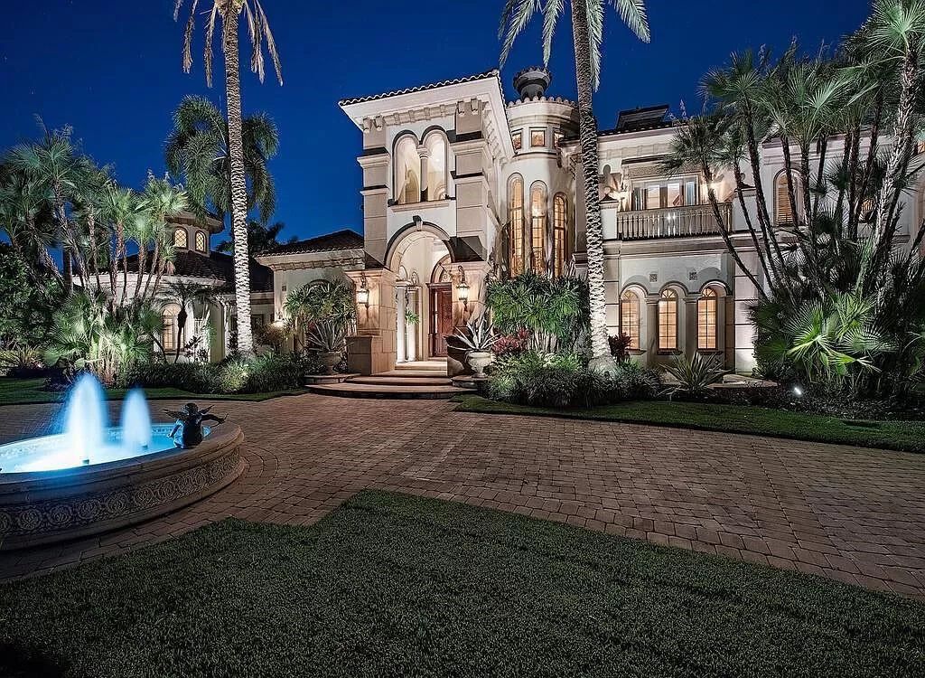 Discover unparalleled luxury living in the prestigious Estates at Bay Colony with this exquisite European-inspired residence nestled on a double lakefront estate.