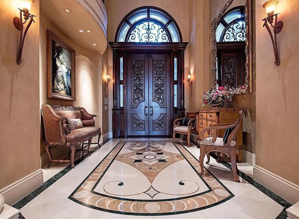 Discover unparalleled luxury living in the prestigious Estates at Bay Colony with this exquisite European-inspired residence nestled on a double lakefront estate.