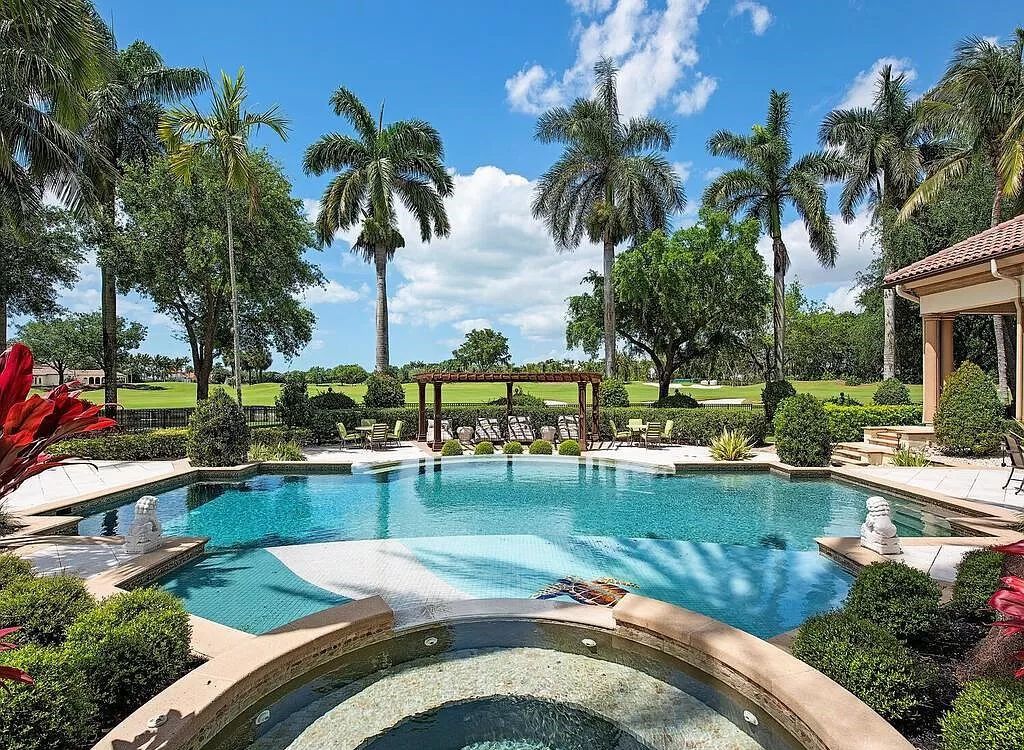 Discover unparalleled luxury living in the prestigious Estates at Bay Colony with this exquisite European-inspired residence nestled on a double lakefront estate.