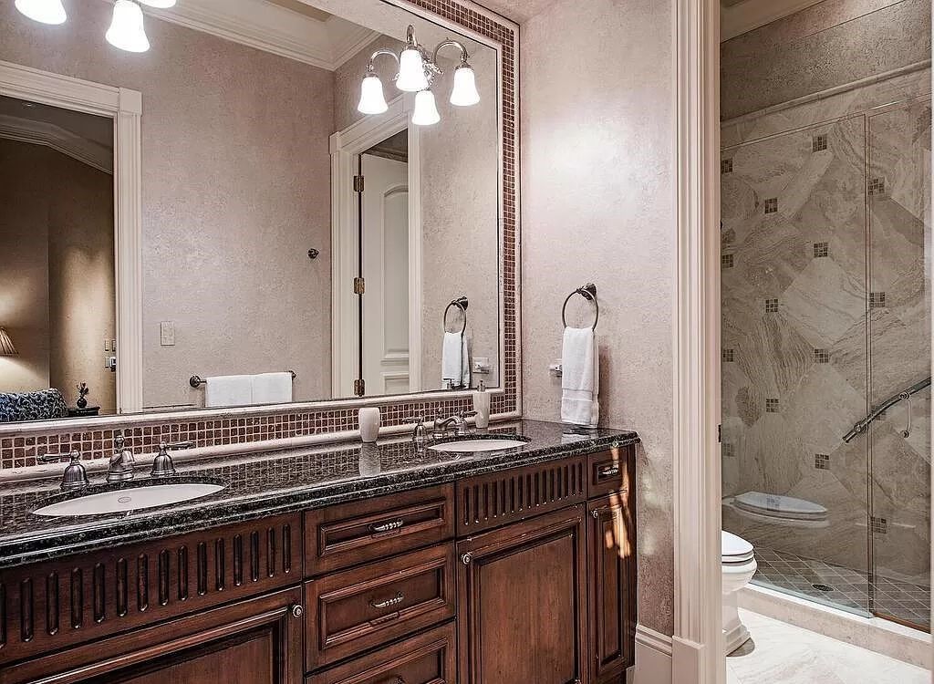 Discover unparalleled luxury living in the prestigious Estates at Bay Colony with this exquisite European-inspired residence nestled on a double lakefront estate.