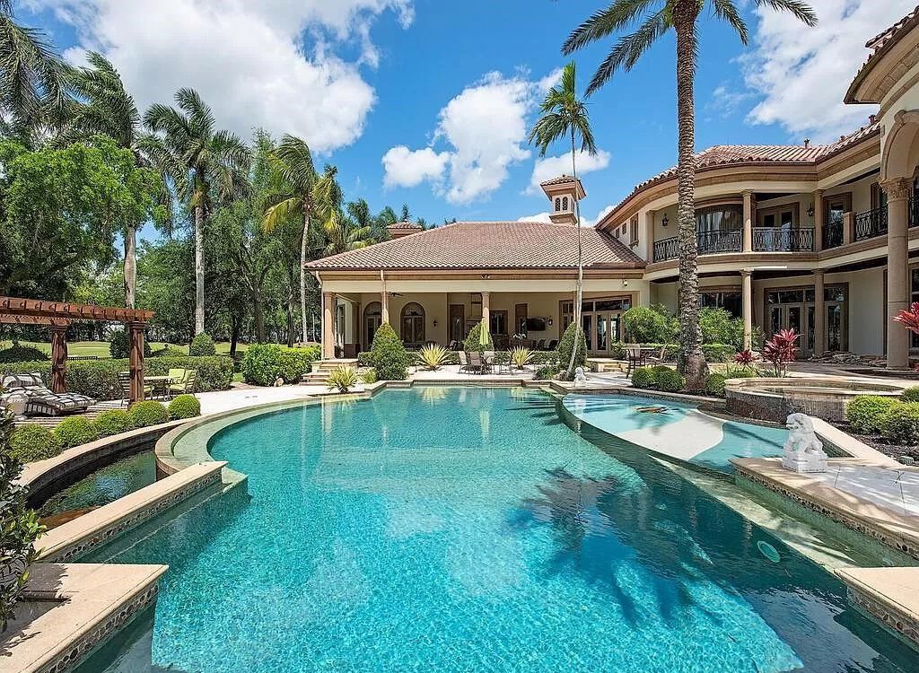 Discover unparalleled luxury living in the prestigious Estates at Bay Colony with this exquisite European-inspired residence nestled on a double lakefront estate.