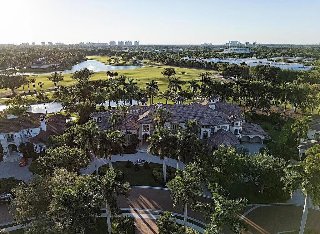 Discover unparalleled luxury living in the prestigious Estates at Bay Colony with this exquisite European-inspired residence nestled on a double lakefront estate.