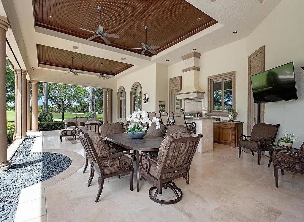 Discover unparalleled luxury living in the prestigious Estates at Bay Colony with this exquisite European-inspired residence nestled on a double lakefront estate.
