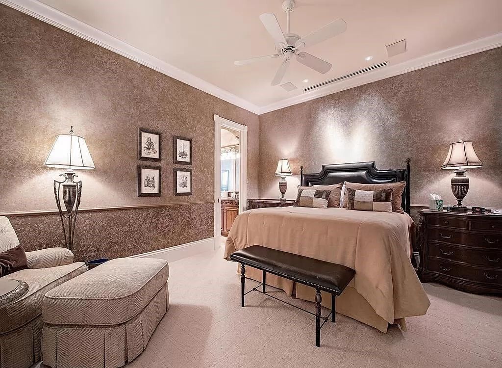 Discover unparalleled luxury living in the prestigious Estates at Bay Colony with this exquisite European-inspired residence nestled on a double lakefront estate.