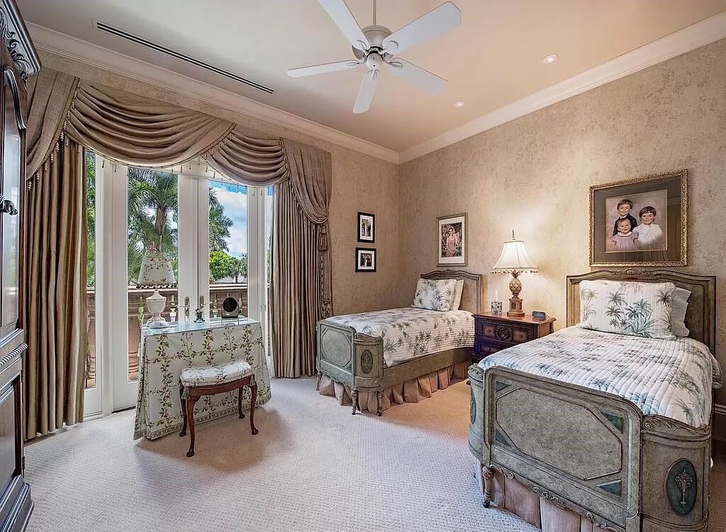 Discover unparalleled luxury living in the prestigious Estates at Bay Colony with this exquisite European-inspired residence nestled on a double lakefront estate.