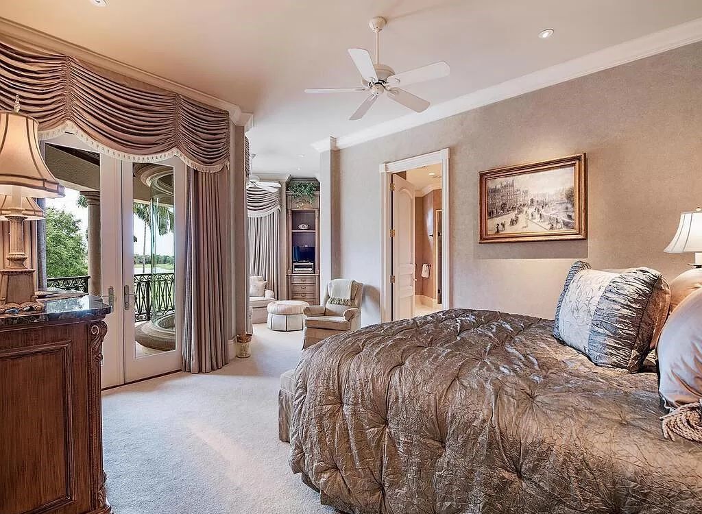 Discover unparalleled luxury living in the prestigious Estates at Bay Colony with this exquisite European-inspired residence nestled on a double lakefront estate.