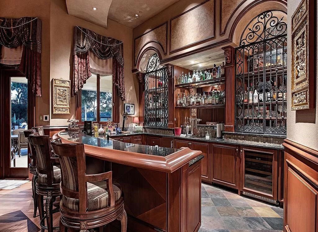 Discover unparalleled luxury living in the prestigious Estates at Bay Colony with this exquisite European-inspired residence nestled on a double lakefront estate.