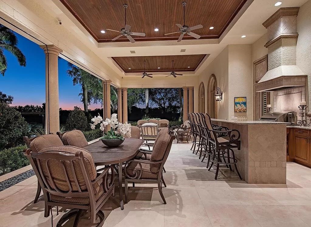 Discover unparalleled luxury living in the prestigious Estates at Bay Colony with this exquisite European-inspired residence nestled on a double lakefront estate.