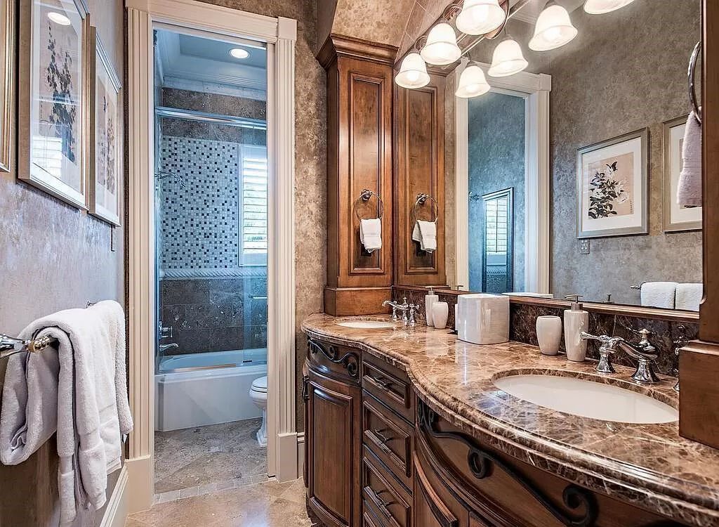 Discover unparalleled luxury living in the prestigious Estates at Bay Colony with this exquisite European-inspired residence nestled on a double lakefront estate.