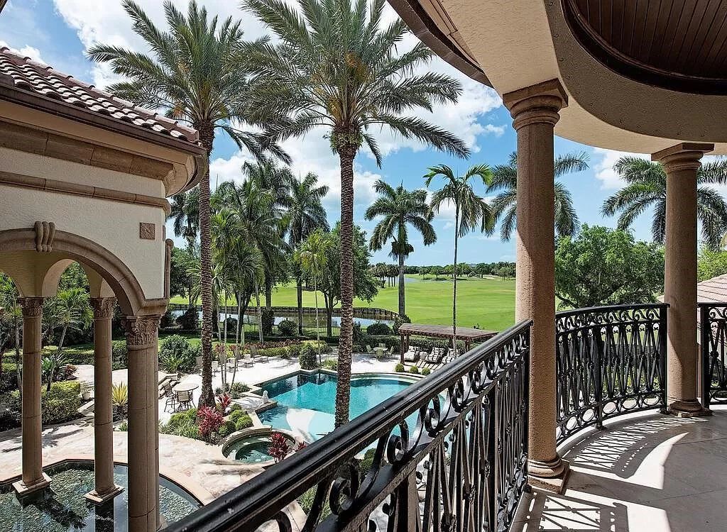 Discover unparalleled luxury living in the prestigious Estates at Bay Colony with this exquisite European-inspired residence nestled on a double lakefront estate.