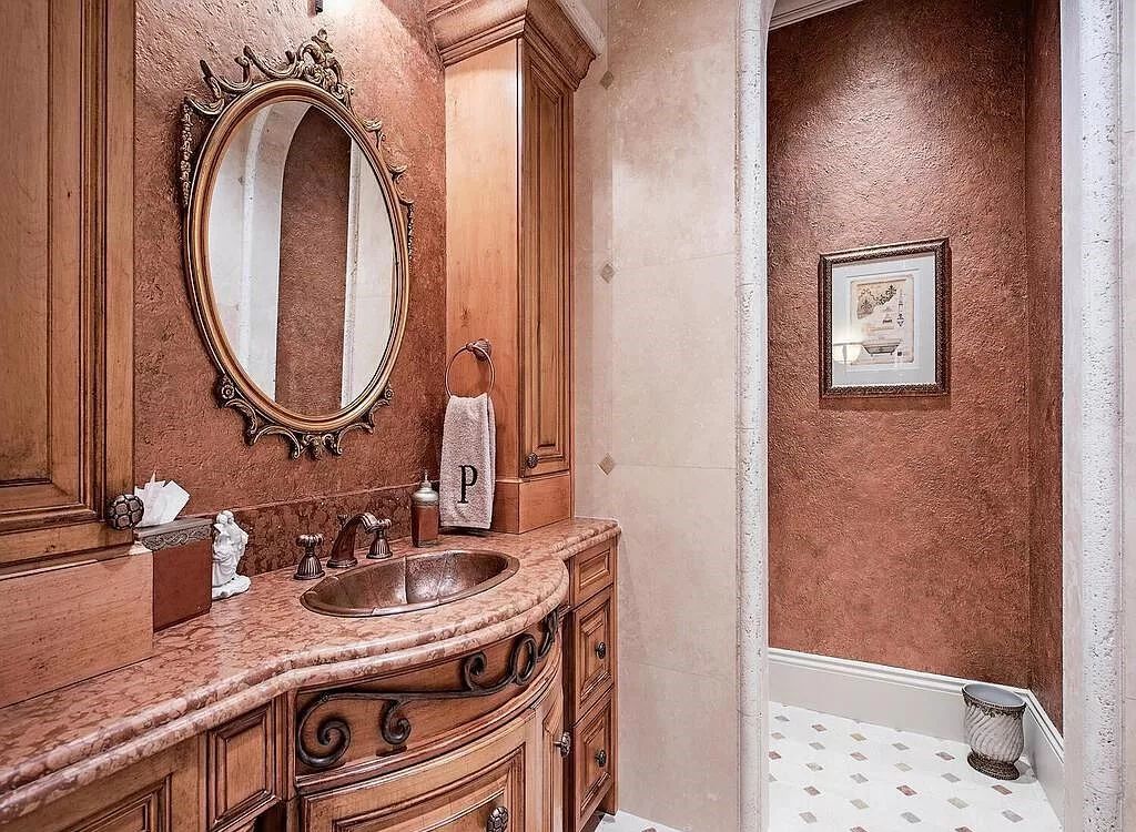 Discover unparalleled luxury living in the prestigious Estates at Bay Colony with this exquisite European-inspired residence nestled on a double lakefront estate.