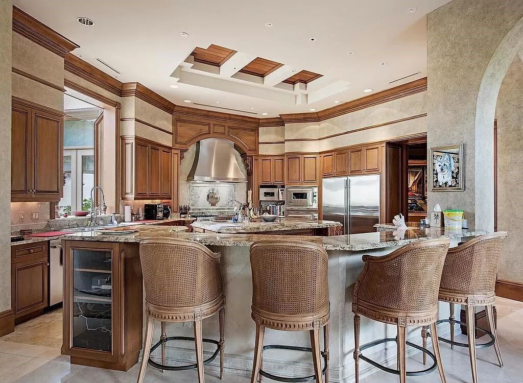 Discover unparalleled luxury living in the prestigious Estates at Bay Colony with this exquisite European-inspired residence nestled on a double lakefront estate.