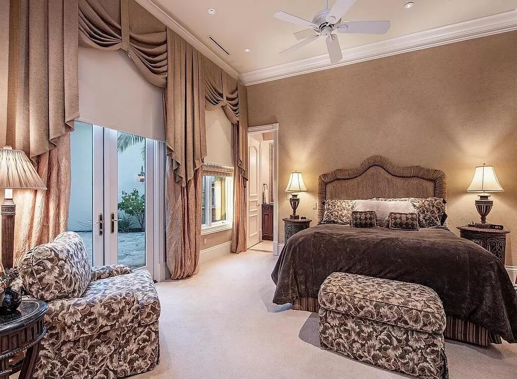 Discover unparalleled luxury living in the prestigious Estates at Bay Colony with this exquisite European-inspired residence nestled on a double lakefront estate.