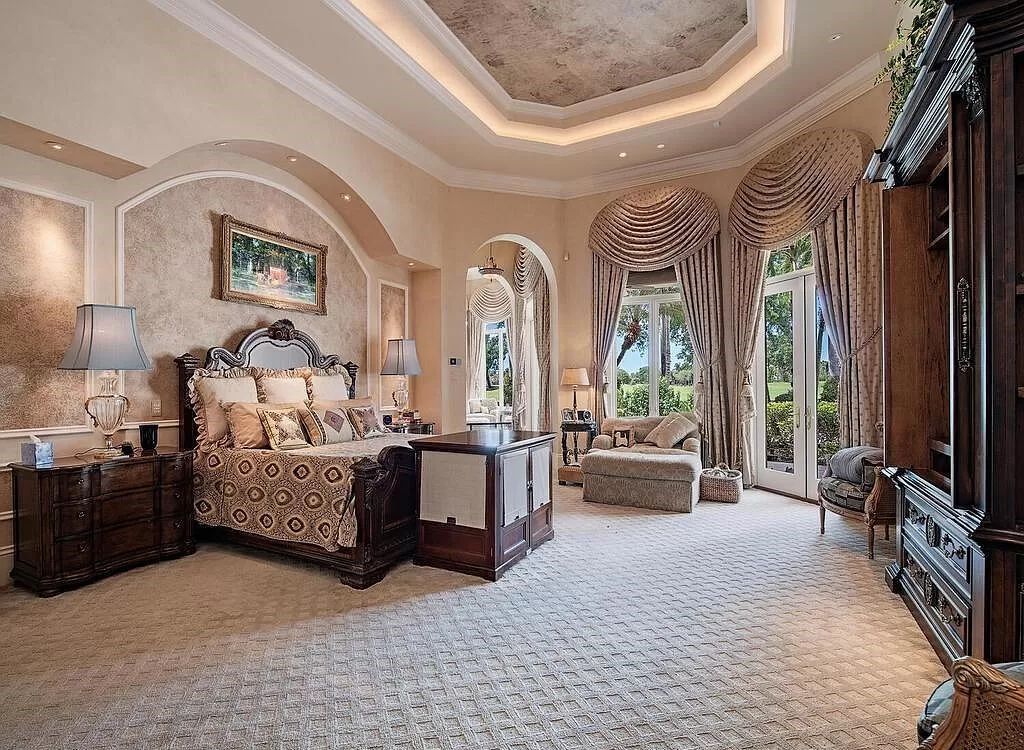 Discover unparalleled luxury living in the prestigious Estates at Bay Colony with this exquisite European-inspired residence nestled on a double lakefront estate.