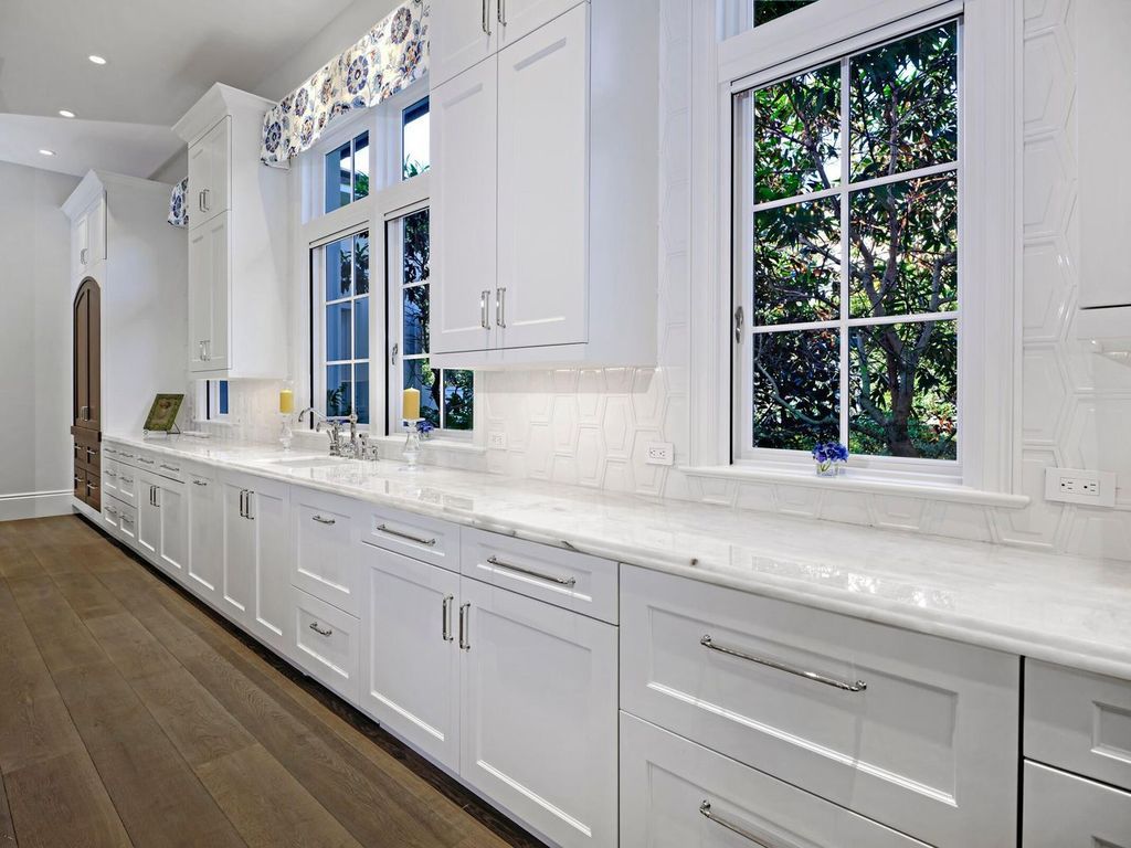 Welcome to 131 W Bears Club Drive, an exclusive retreat in Jupiter's prestigious golf community. This custom-built estate, one of only 48 in the enclave, offers over 12,000 square feet of luxury living on nearly 0.6 acres.
