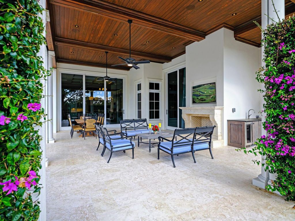 Welcome to 131 W Bears Club Drive, an exclusive retreat in Jupiter's prestigious golf community. This custom-built estate, one of only 48 in the enclave, offers over 12,000 square feet of luxury living on nearly 0.6 acres.
