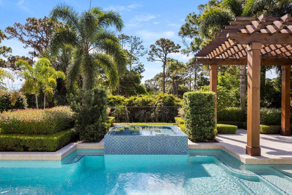Welcome to 131 W Bears Club Drive, an exclusive retreat in Jupiter's prestigious golf community. This custom-built estate, one of only 48 in the enclave, offers over 12,000 square feet of luxury living on nearly 0.6 acres.