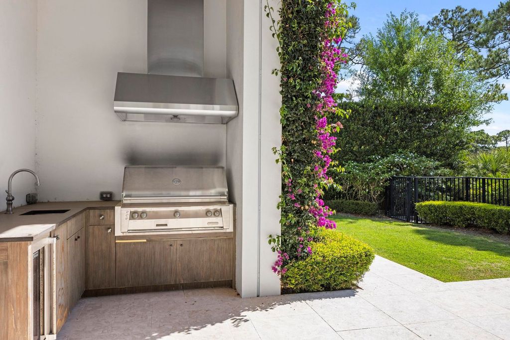 Welcome to 131 W Bears Club Drive, an exclusive retreat in Jupiter's prestigious golf community. This custom-built estate, one of only 48 in the enclave, offers over 12,000 square feet of luxury living on nearly 0.6 acres.