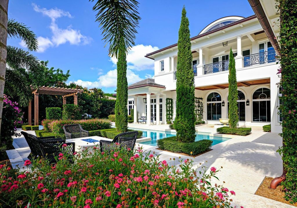 Welcome to 131 W Bears Club Drive, an exclusive retreat in Jupiter's prestigious golf community. This custom-built estate, one of only 48 in the enclave, offers over 12,000 square feet of luxury living on nearly 0.6 acres.