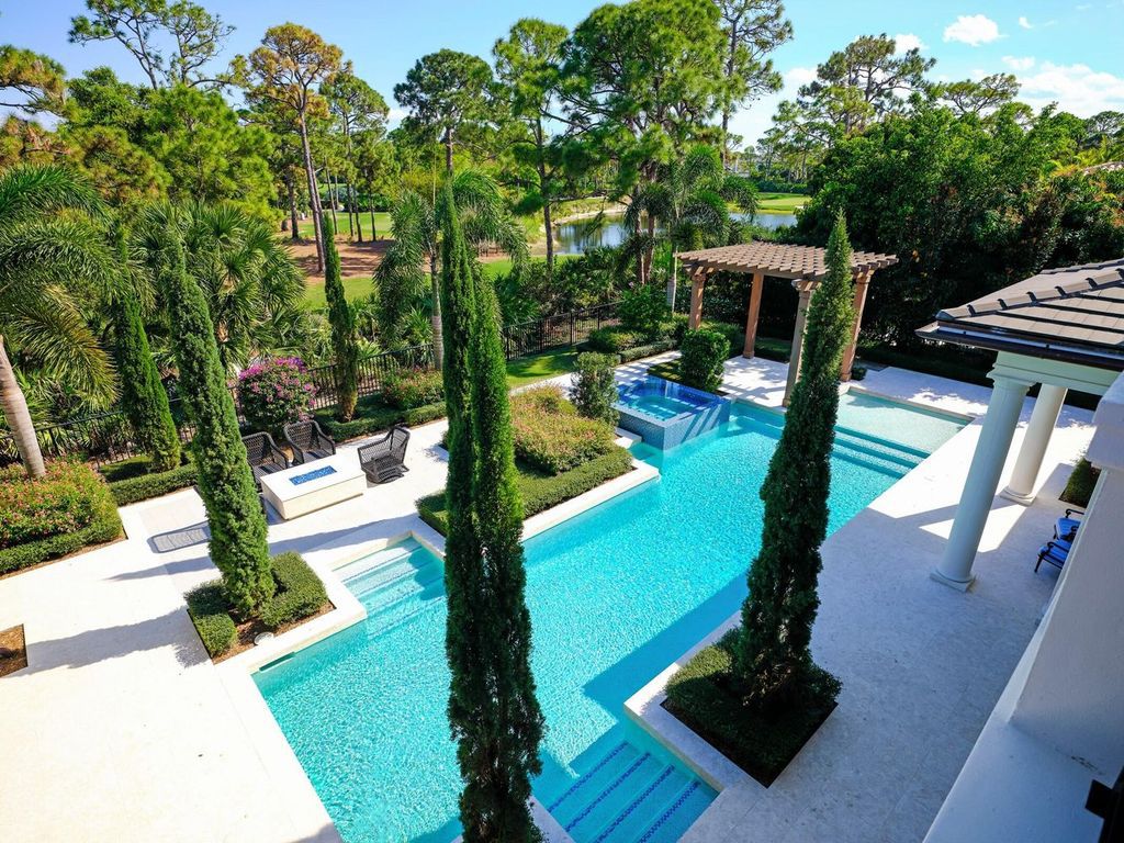 Welcome to 131 W Bears Club Drive, an exclusive retreat in Jupiter's prestigious golf community. This custom-built estate, one of only 48 in the enclave, offers over 12,000 square feet of luxury living on nearly 0.6 acres.