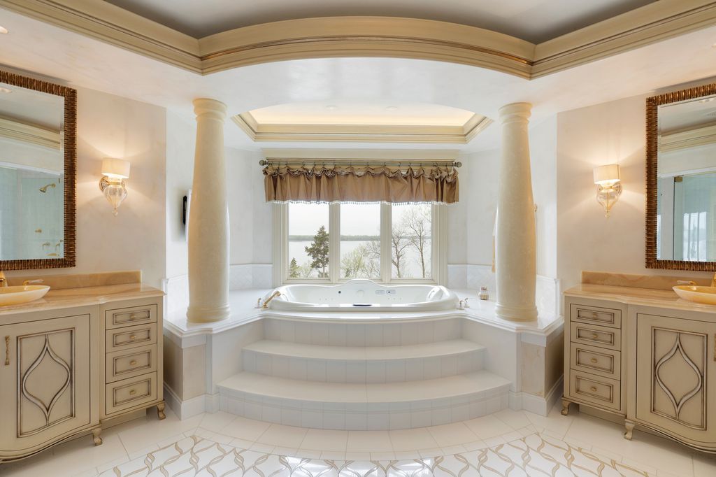 3770 Northome Road Home in Wayzata, Minnesota. Discover the epitome of luxury living on Lake Minnetonka with this John Kraemer & Sons masterpiece. From the luxurious master suite to the state-of-the-art amenities including a bowling alley, golf simulator, and Cavern Music Club, no detail has been overlooked. 