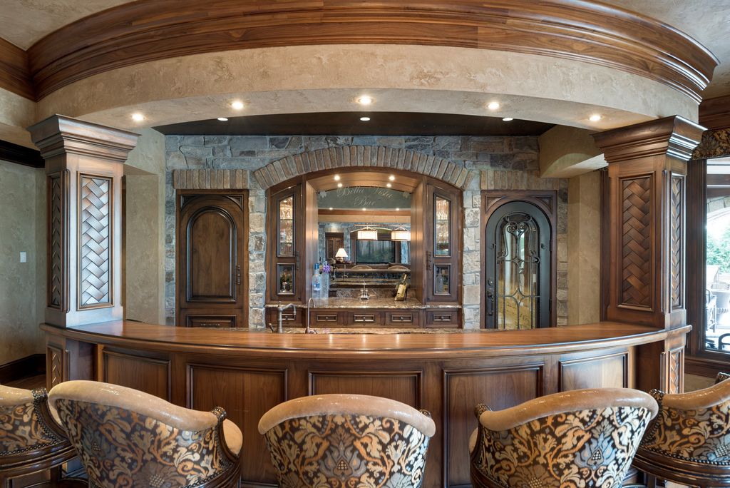 3770 Northome Road Home in Wayzata, Minnesota. Discover the epitome of luxury living on Lake Minnetonka with this John Kraemer & Sons masterpiece. From the luxurious master suite to the state-of-the-art amenities including a bowling alley, golf simulator, and Cavern Music Club, no detail has been overlooked. 