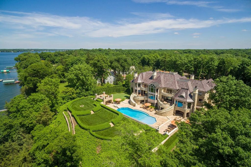 3770 Northome Road Home in Wayzata, Minnesota. Discover the epitome of luxury living on Lake Minnetonka with this John Kraemer & Sons masterpiece. From the luxurious master suite to the state-of-the-art amenities including a bowling alley, golf simulator, and Cavern Music Club, no detail has been overlooked. 