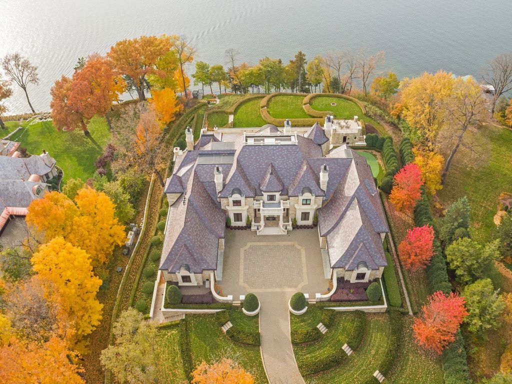 3770 Northome Road Home in Wayzata, Minnesota. Discover the epitome of luxury living on Lake Minnetonka with this John Kraemer & Sons masterpiece. From the luxurious master suite to the state-of-the-art amenities including a bowling alley, golf simulator, and Cavern Music Club, no detail has been overlooked. 