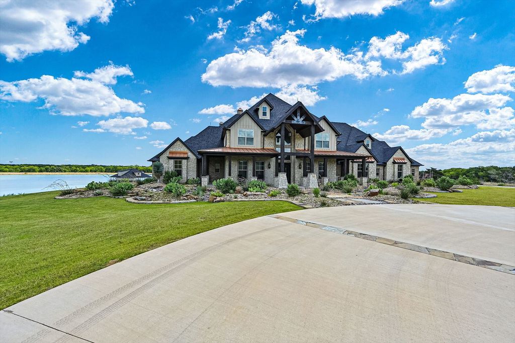 430 Chaparall Road Home in Ferris, Texas. Discover this breathtaking custom lake home nestled on 514 secluded acres, just 15 minutes south of Dallas. Meticulously constructed with stunning lake views from every room, this home features vaulted ceilings, a chef's dream kitchen, luxurious owner's suite, formal dining, study, and more. 