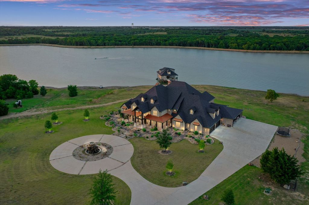 430 Chaparall Road Home in Ferris, Texas. Discover this breathtaking custom lake home nestled on 514 secluded acres, just 15 minutes south of Dallas. Meticulously constructed with stunning lake views from every room, this home features vaulted ceilings, a chef's dream kitchen, luxurious owner's suite, formal dining, study, and more. 