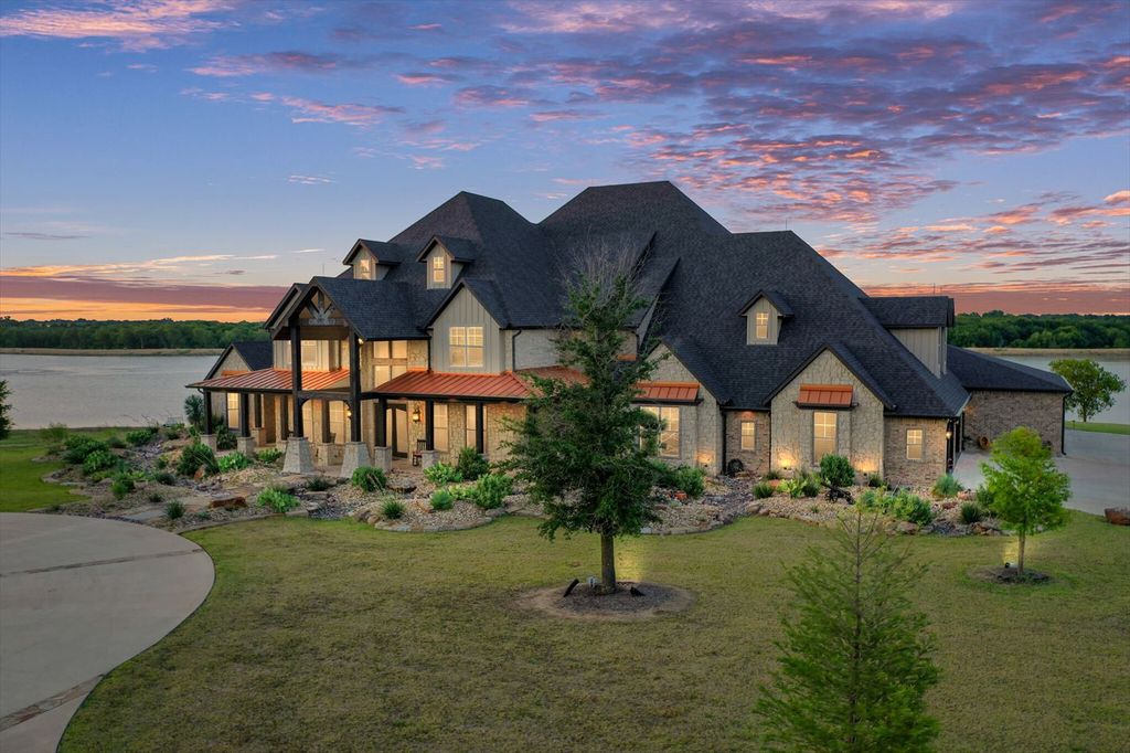 430 Chaparall Road Home in Ferris, Texas. Discover this breathtaking custom lake home nestled on 514 secluded acres, just 15 minutes south of Dallas. Meticulously constructed with stunning lake views from every room, this home features vaulted ceilings, a chef's dream kitchen, luxurious owner's suite, formal dining, study, and more. 