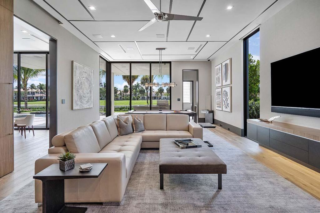 This prestigious Signature Estate within the Royal Palm Yacht & Country Club offers breathtaking views of lush golf course fairways.