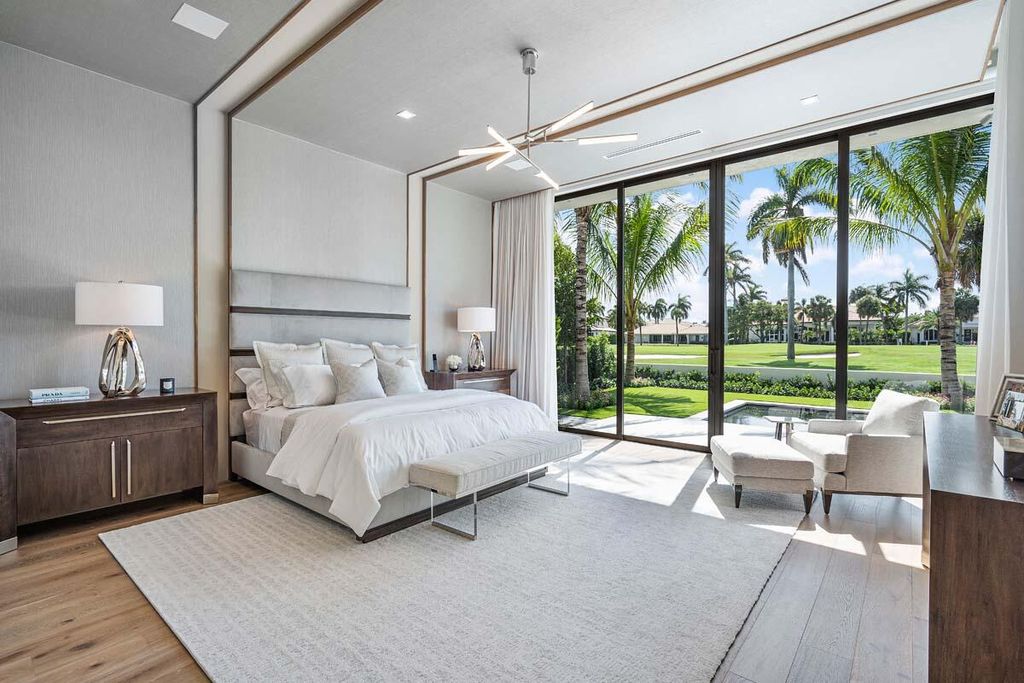 This prestigious Signature Estate within the Royal Palm Yacht & Country Club offers breathtaking views of lush golf course fairways.