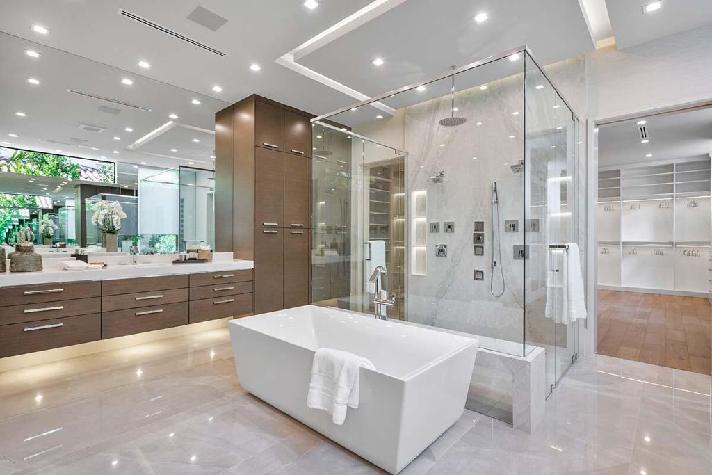 This prestigious Signature Estate within the Royal Palm Yacht & Country Club offers breathtaking views of lush golf course fairways.
